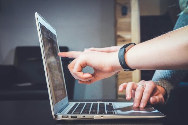 Hand pointing at a computer