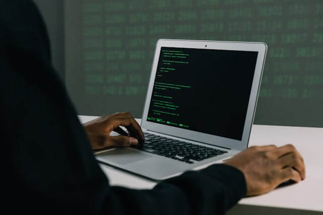 a guy writing code on a computer